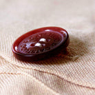 Christmas North Pole City Holiday Embroidered Pillow - detail of decorative button closure