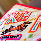 Christmas North Pole Holiday Embroidered Pillow - close-up detail of hand-embroidered needlepoint stitching