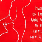 Closeup of Christmas Peace On Earth Dog needlepoint throw pillow highlighting hand-stitched wool craftsmanship and fabric detail
