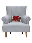 Christmas Poinsettia Hooked Wool Throw Pillow on an armchair, showing the throw pillow at room scale, 8x12 inch