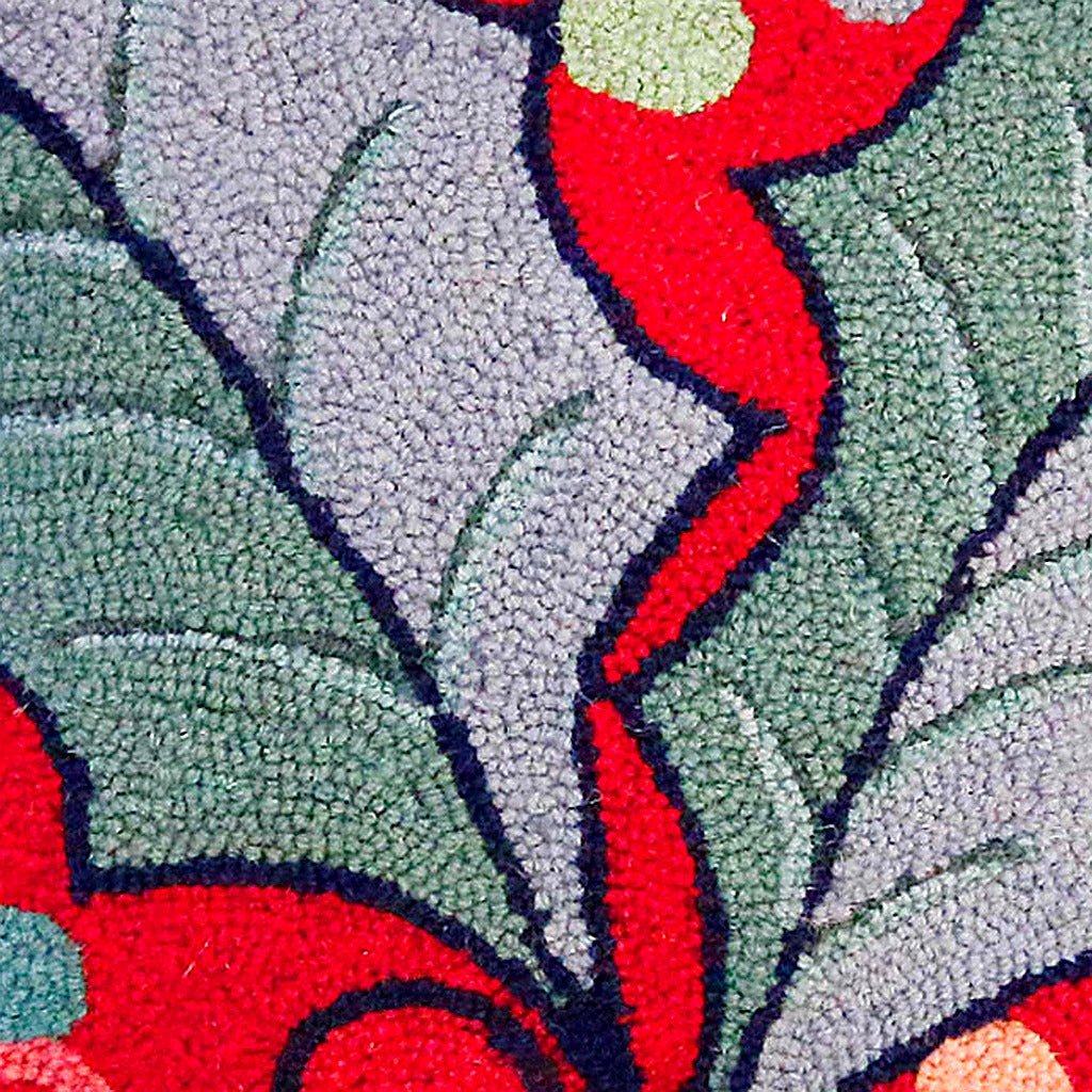 Closeup of Christmas Red Holly Leaves Wool Hooked needlepoint throw pillow highlighting hand-stitched wool craftsmanship and fabric detail