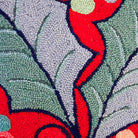 Closeup of Christmas Red Holly Leaves Wool Hooked needlepoint throw pillow highlighting hand-stitched wool craftsmanship and fabric detail