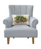 Christmas Tree on Sled Hooked Wool Throw Pillow on an armchair, showing the throw pillow at room scale, 12x18 inch