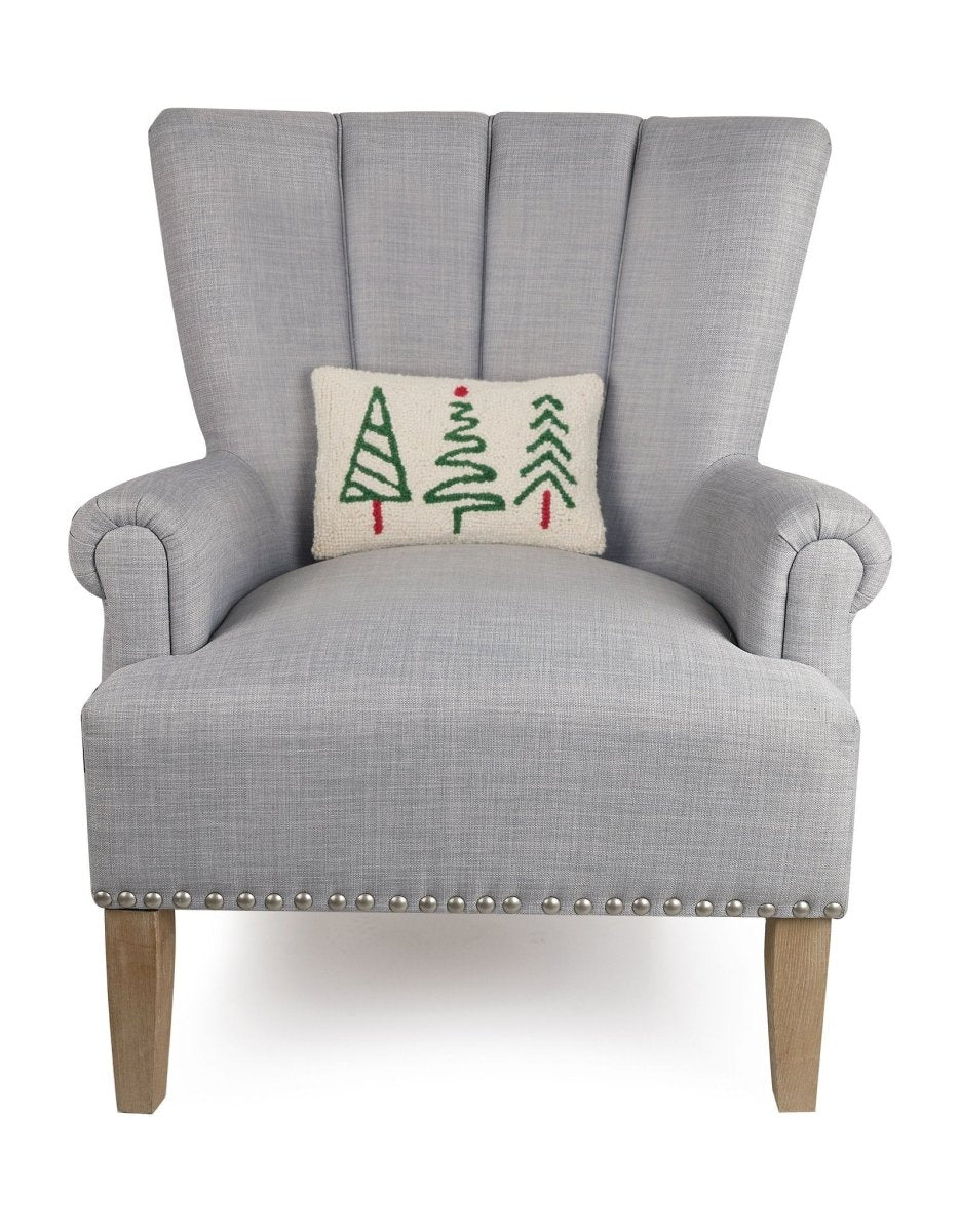 Christmas Trees Trio Hooked Wool Throw Pillow on an armchair, showing the throw pillow at room scale, 8x12 inch