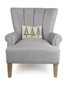Christmas Trees Trio Hooked Wool Throw Pillow on an armchair, showing the throw pillow at room scale, 8x12 inch