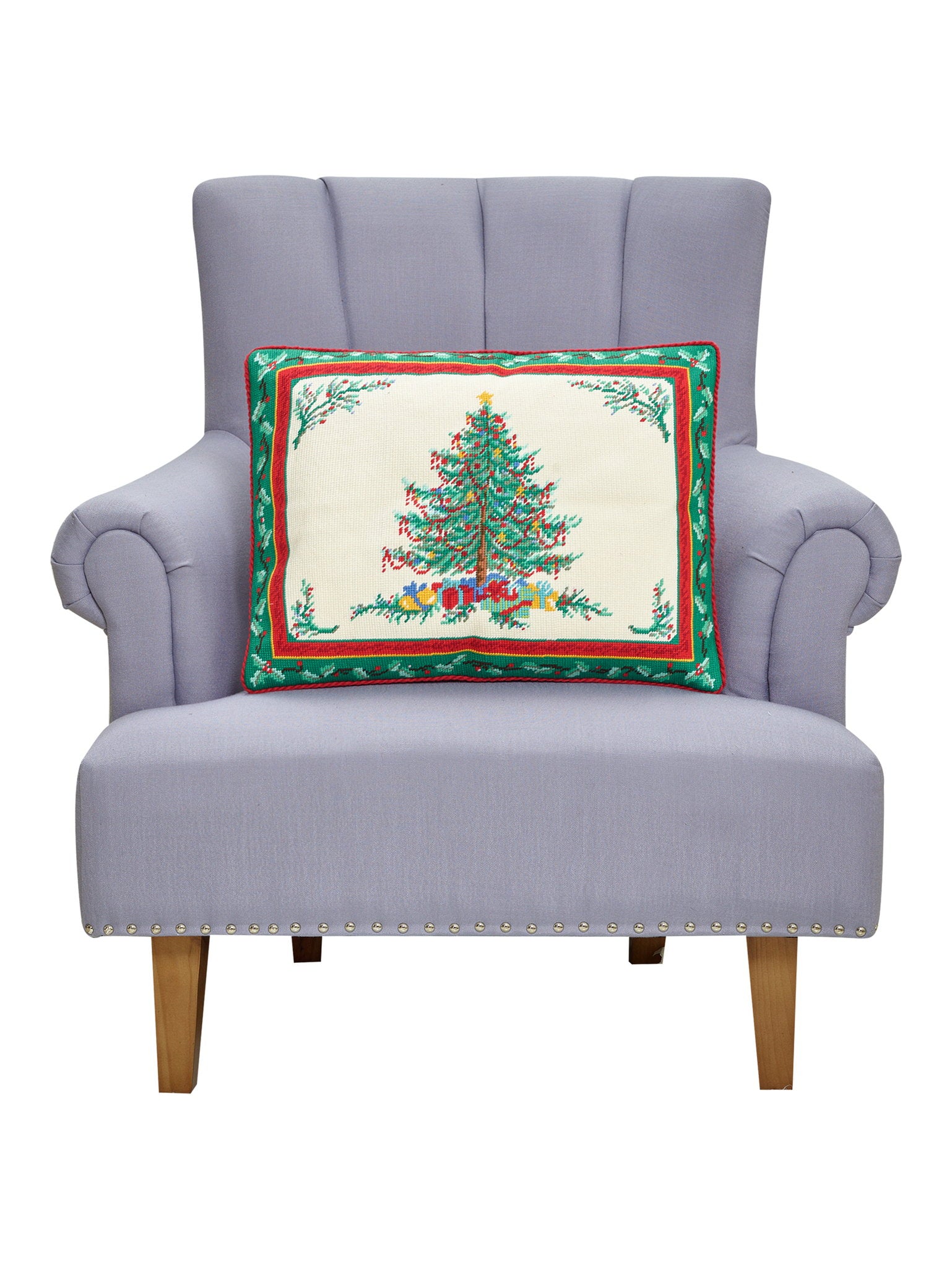 Classic Christmas Embroidered Needlepoint Throw Pillow on an armchair, showing the throw pillow at room scale, 16x20 inch