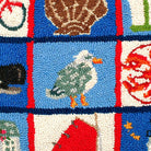 Closeup of Coastal Quilt Nautical needlepoint throw pillow highlighting hand-stitched wool craftsmanship and fabric detail