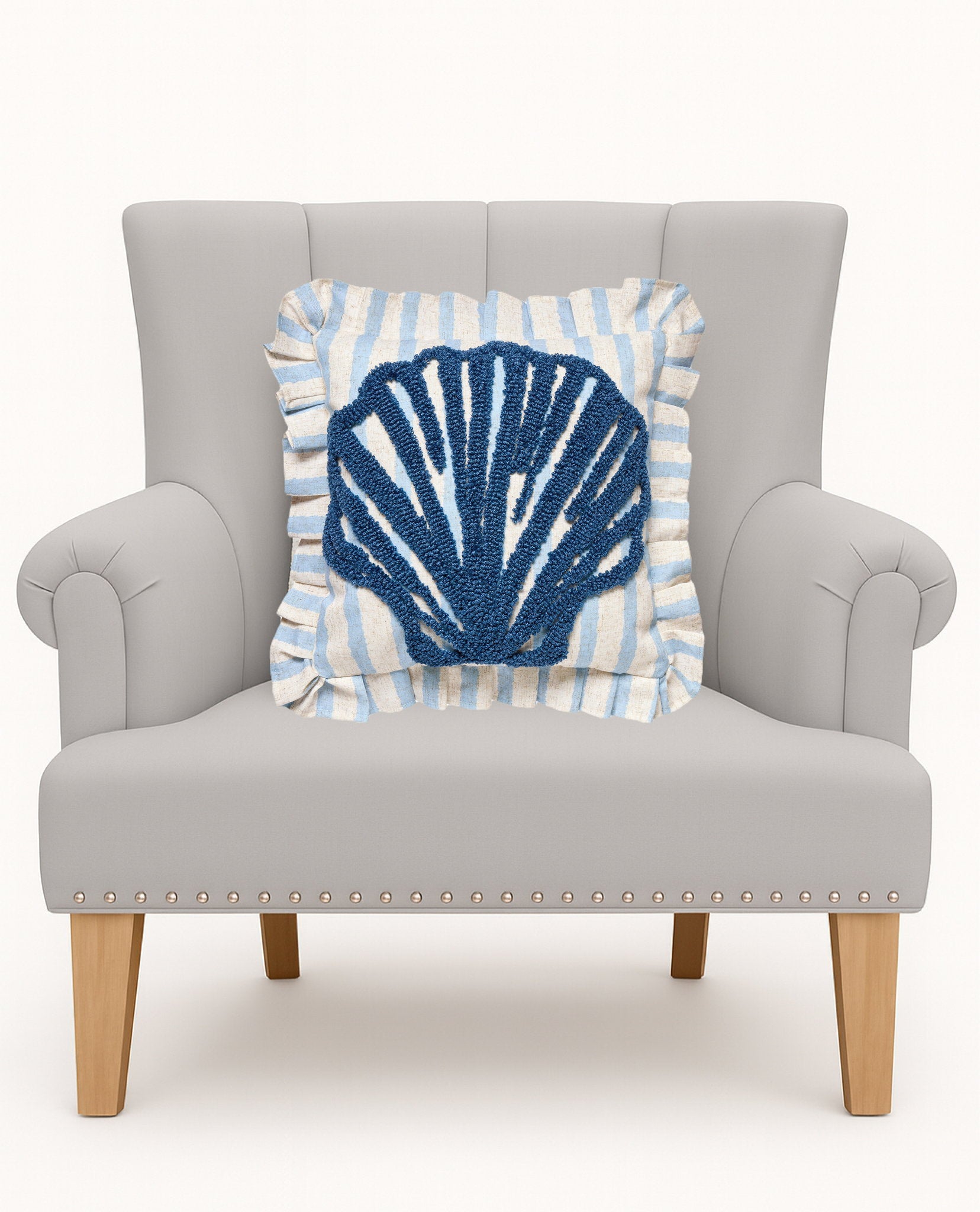 Coastal Shell Tufted Hooked Throw Pillow on an armchair, showing the throw pillow at room scale, 16x16 inch