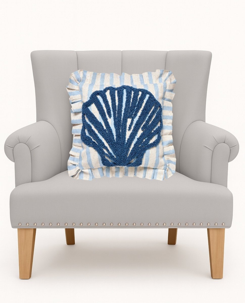Coastal Shell Tufted Hooked Throw Pillow on an armchair, showing the throw pillow at room scale, 16x16 inch