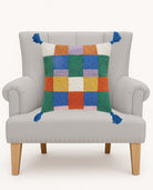 Colorful Check with Tassels Hooked Wool Throw Pillow on an armchair, showing the throw pillow at room scale, 16x16 inch