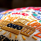 Columbus, OH Discovery City Embroidered Travel Pillow - close-up detail of hand-embroidered needlepoint stitching