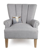 Cow Skull Hooked Wool Halloween Throw Pillow on an armchair, showing the throw pillow at room scale, 8x18 inch