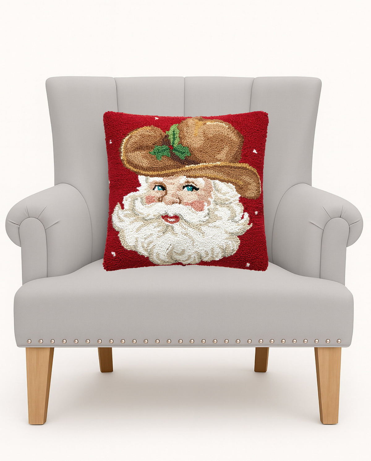 Cowboy Hat Retro Santa Hooked Wool Christmas Throw Pillow on an armchair, showing the throw pillow at room scale, 16x16 inch