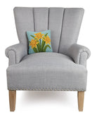 Daffodil Hooked Wool Throw Pillow on an armchair, showing the throw pillow at room scale, 10x10 inch