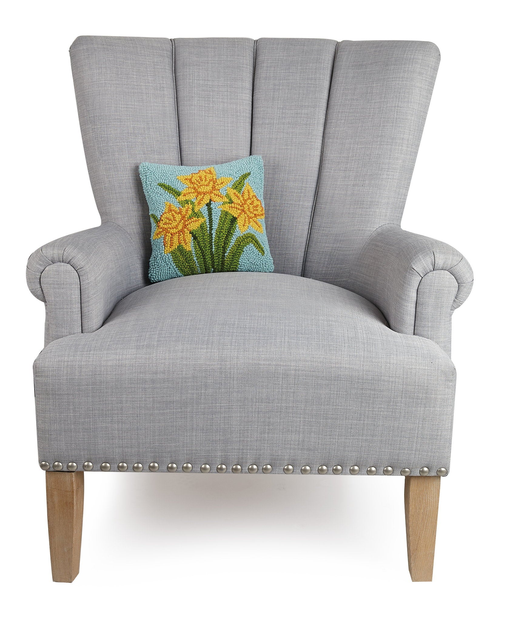 Daffodil Hooked Wool Throw Pillow on an armchair, showing the throw pillow at room scale, 10x10 inch