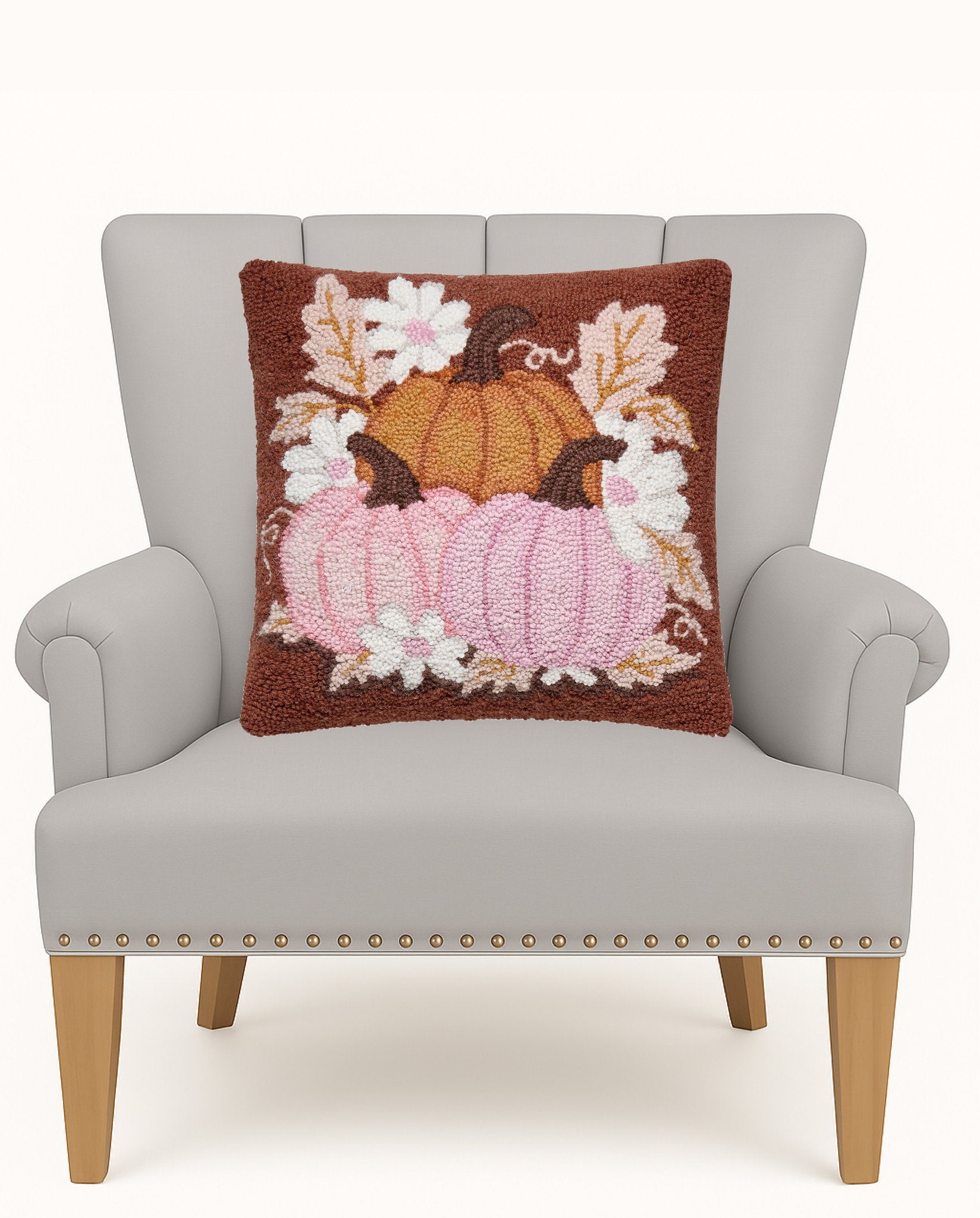 Daisies and Pumpkin Trio Hooked Wool Fall Harvest Throw Pillow on an armchair, showing the throw pillow at room scale, 16x16 inch