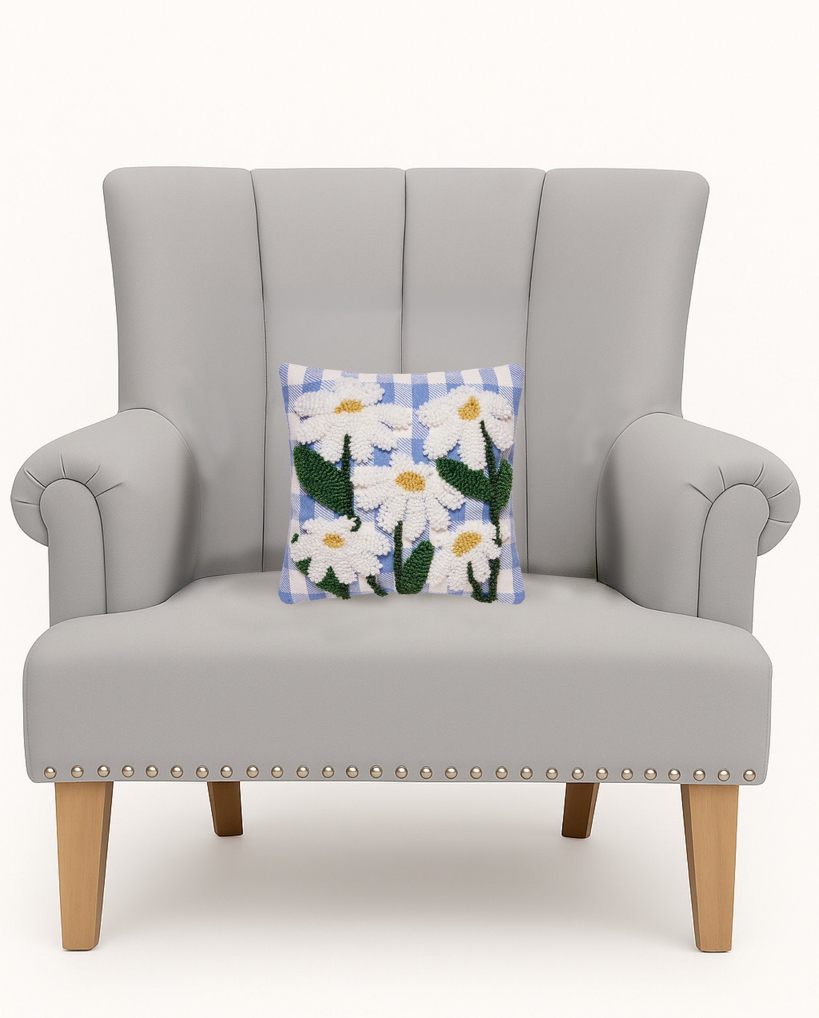 Daisies Tufted Poly Hooked Throw Pillow on an armchair, showing the throw pillow at room scale, 10x10 inch