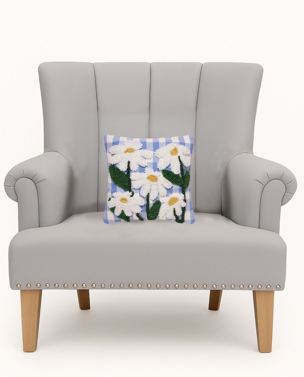 Daisies Tufted Poly Hooked Throw Pillow on an armchair, showing the throw pillow at room scale, 10x10 inch