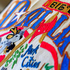 Dallas, TX Big D City Embroidered Travel Throw Pillow - close-up detail of hand-embroidered needlepoint stitching