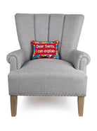 Dear Santa Embroidered Needlepoint Christmas Throw Pillow on an armchair, showing the throw pillow at room scale, 8x12 inch