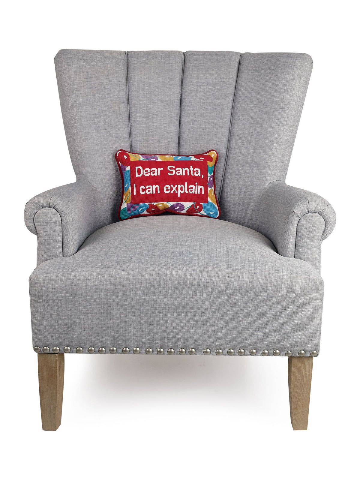 Dear Santa Embroidered Needlepoint Christmas Throw Pillow on an armchair, showing the throw pillow at room scale, 8x12 inch