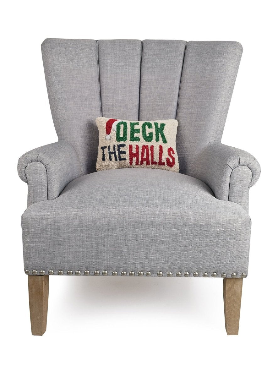 Deck the Halls Hooked Wool Christmas Throw Pillow on an armchair, showing the throw pillow at room scale, 8x12 inch