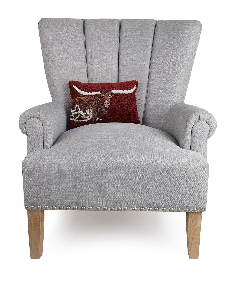 Deep Red Longhorn Hooked Wool Throw Pillow on an armchair, showing the throw pillow at room scale, 8x12 inch
