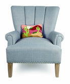 Desert Cactus Sunset Hooked Wool Throw Pillow on an armchair, showing the throw pillow at room scale, 8x12 inch