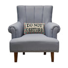 Do Not Disturb Hooked Wool Throw Pillow on an armchair, showing the throw pillow at room scale, 9x16 inch