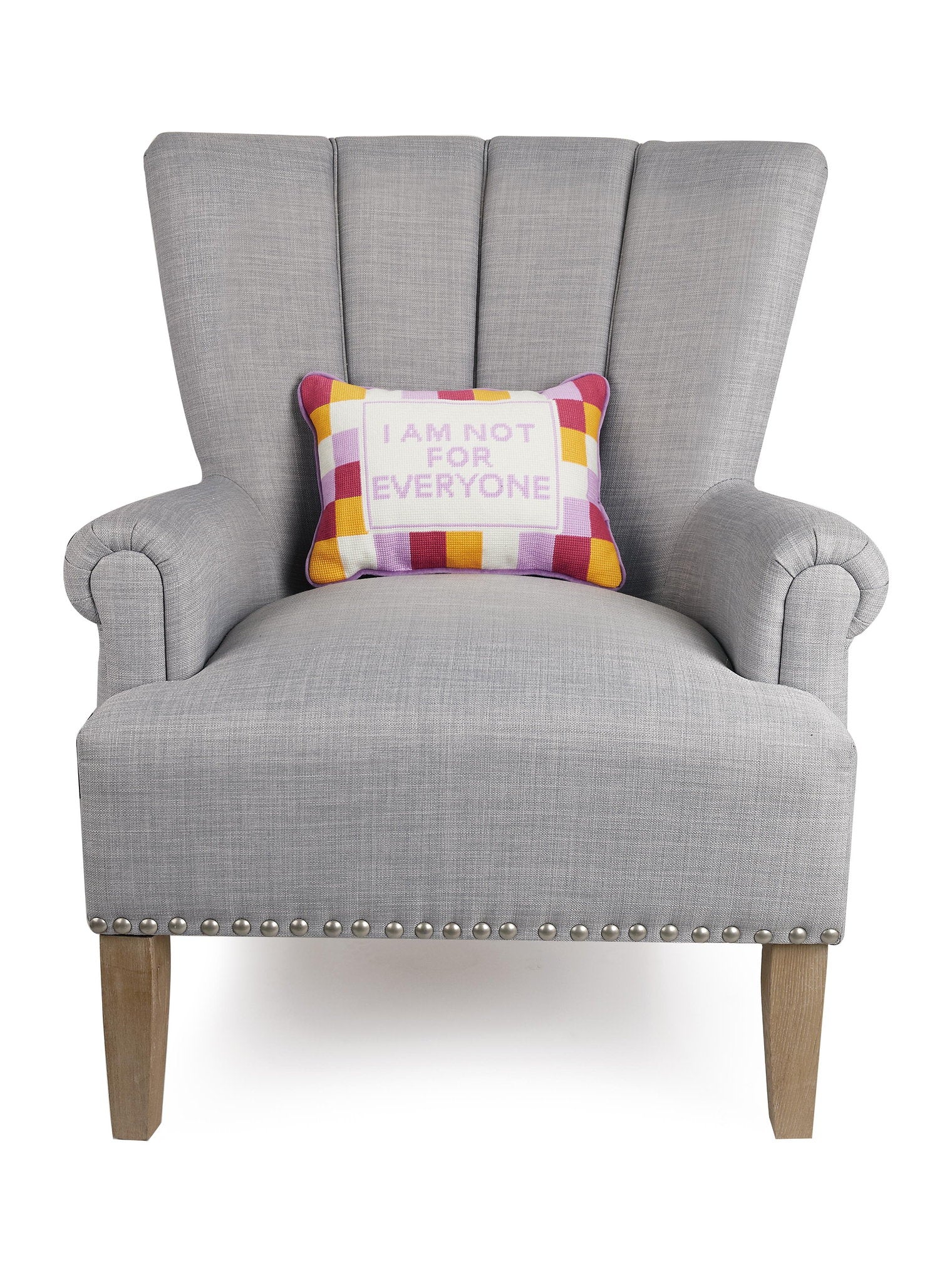 Everyone Embroidered Needlepoint Throw Pillow on an armchair, showing the throw pillow at room scale, 10x14 inch