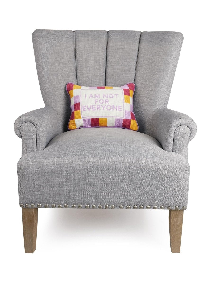 Everyone Embroidered Needlepoint Throw Pillow on an armchair, showing the throw pillow at room scale, 10x14 inch