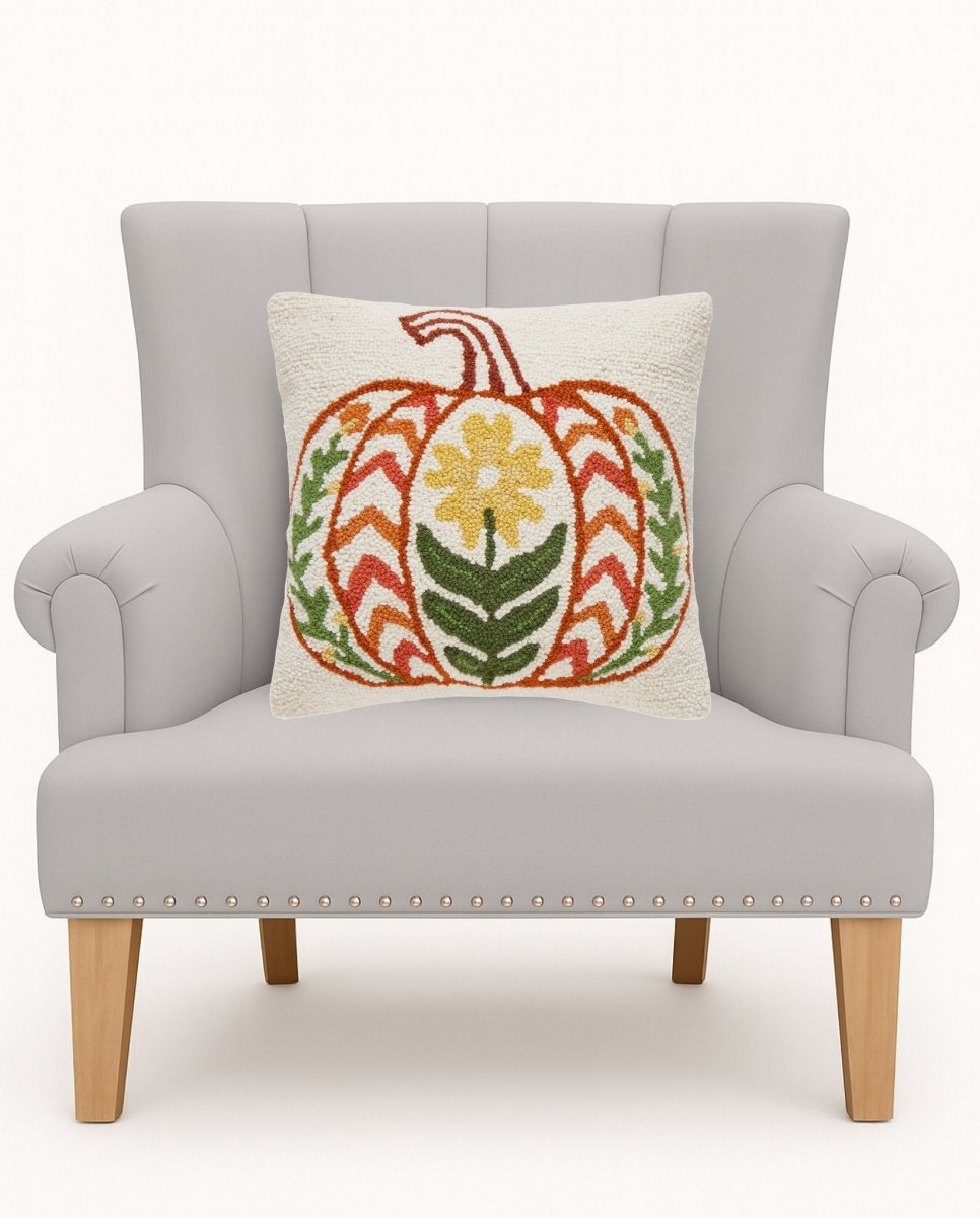 Fall Folk Pumpkin Hooked Wool Throw Pillow on an armchair, showing the throw pillow at room scale, 16x16 inch