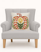 Fall Folk Pumpkin Hooked Wool Throw Pillow on an armchair, showing the throw pillow at room scale, 16x16 inch
