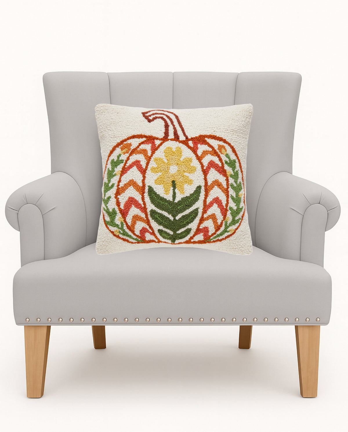 Fall Folk Pumpkin Hooked Wool Throw Pillow on an armchair, showing the throw pillow at room scale, 16x16 inch