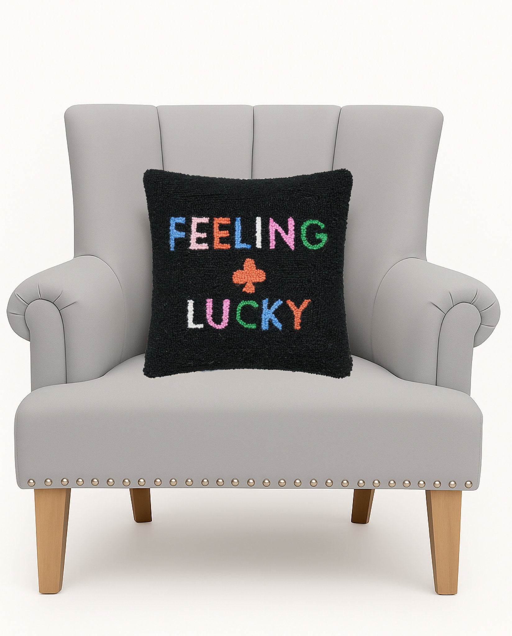 Feeling Lucky Hooked Wool Throw Pillow on an armchair, showing the throw pillow at room scale, 14x14 inch