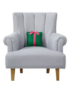 Felt Green Present Embroidered Throw Pillow on an armchair, showing the throw pillow at room scale, 10x10 inch