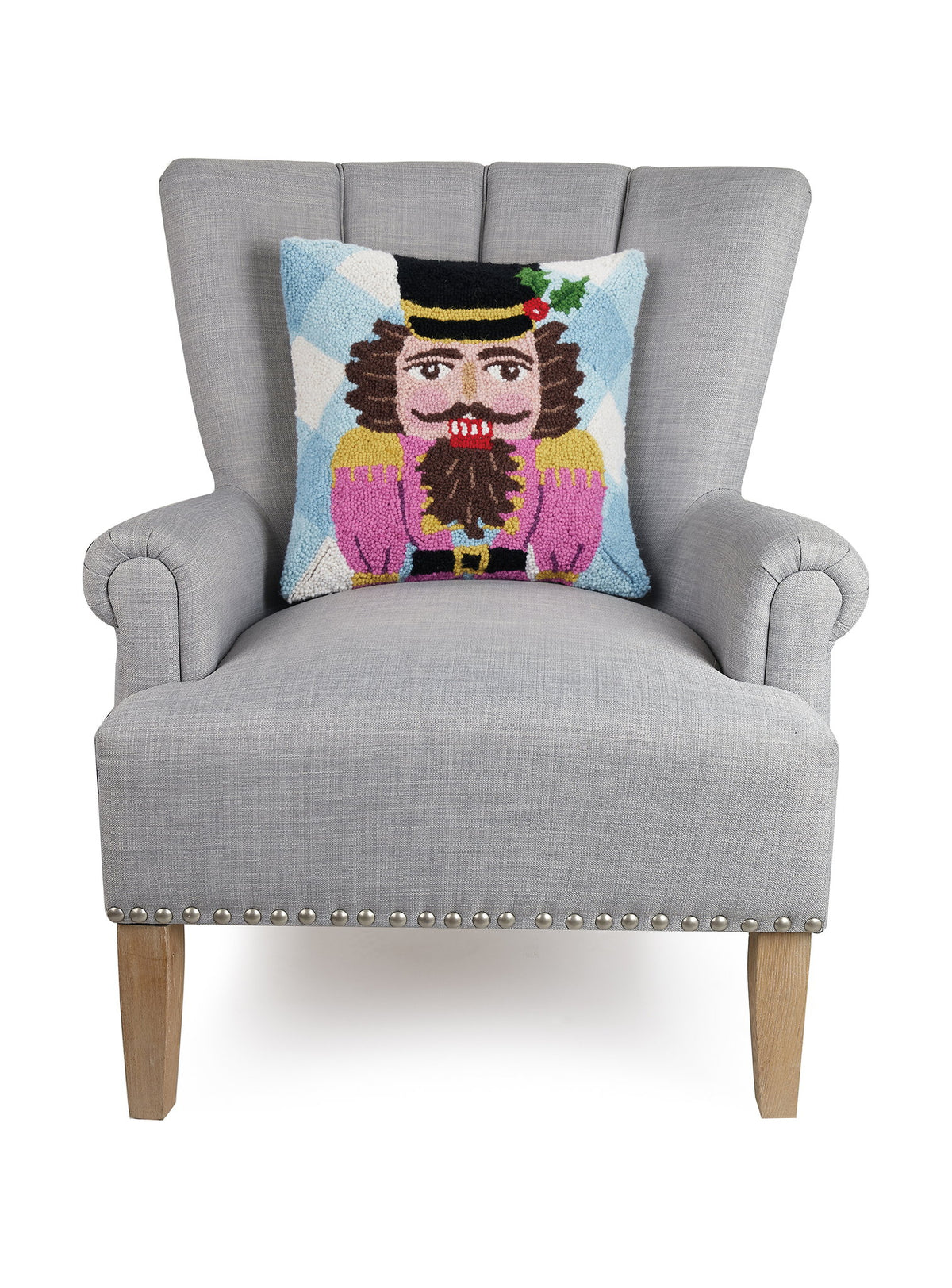 Festive Gingham Nutcracker Hooked Wool Christmas Throw Pillow on an armchair, showing the throw pillow at room scale, 16x16 inch