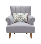 Festive Greenery Snowflakes Embroidered Christmas Throw Pillow on an armchair, showing the throw pillow at room scale, 14x20 inch
