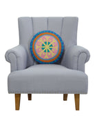 Festive Mandala Hooked Wool Christmas Throw Pillow on an armchair, showing the throw pillow at room scale, 16x16 inch