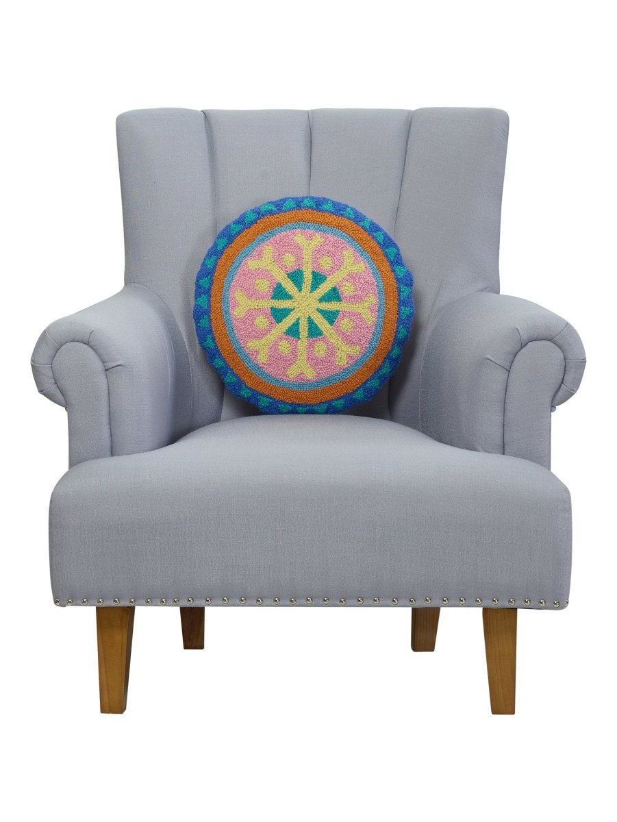 Festive Mandala Hooked Wool Christmas Throw Pillow on an armchair, showing the throw pillow at room scale, 16x16 inch