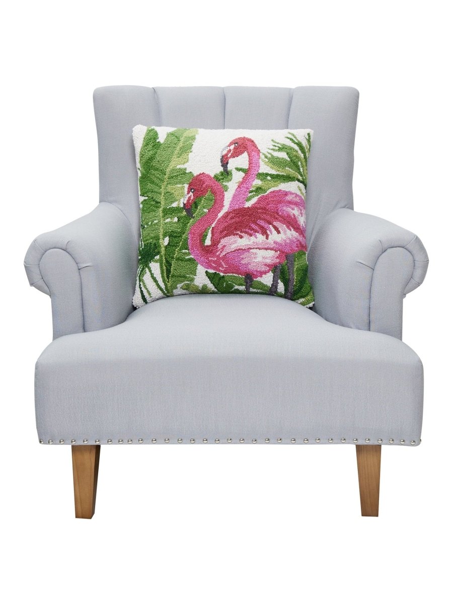 Flamingo Tropics Hooked Wool Throw Pillow on an armchair, showing the throw pillow at room scale, 18x18 inch
