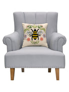 Floral Natural Bee Embroidered Throw Pillow on an armchair, showing the throw pillow at room scale, 16x16 inch