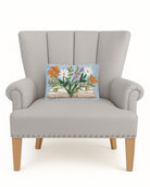 Flower Book Hooked Wool Throw Pillow on an armchair, showing the throw pillow at room scale, 8x12 inch