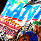 Franklin, TN Heritage Town Embroidered Travel Pillow - close-up detail of hand-embroidered needlepoint stitching