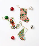 Full Figure Nutcracker Mini Embroidered Needlepoint Christmas Stocking, 6x4 inch, three stockings laid flat with red and green baubles