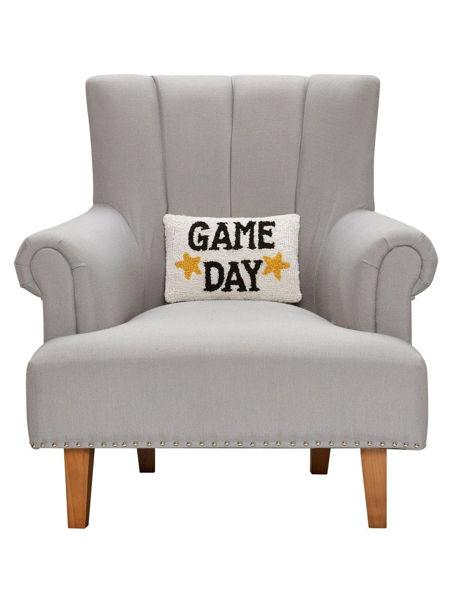 Game Day Hooked Wool Throw Pillow on an armchair, showing the throw pillow at room scale, 8x12 inch