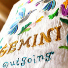Gemini Astrology Zodiac Embroidered Throw Pillow - close-up detail of hand-embroidered needlepoint stitching