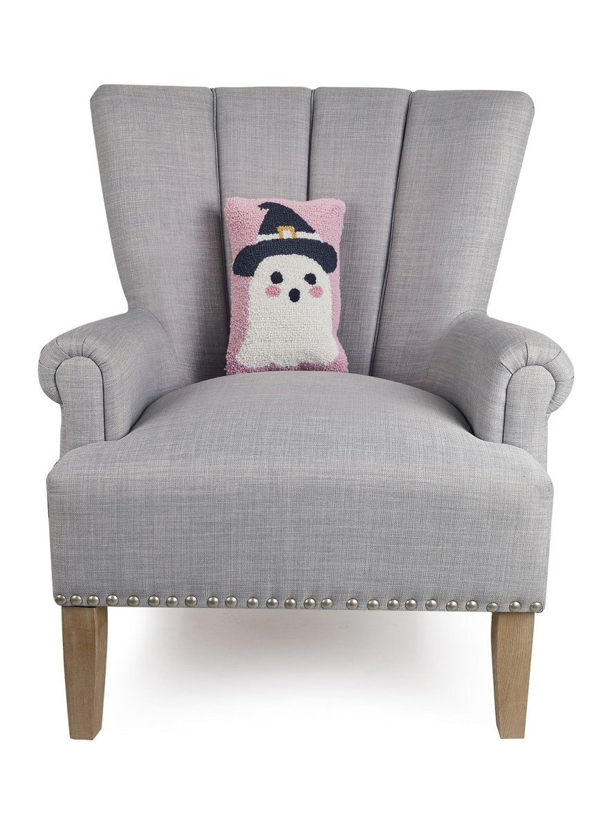 Ghost Witch Hooked Wool Halloween Throw Pillow on an armchair, showing the throw pillow at room scale, 8x12 inch