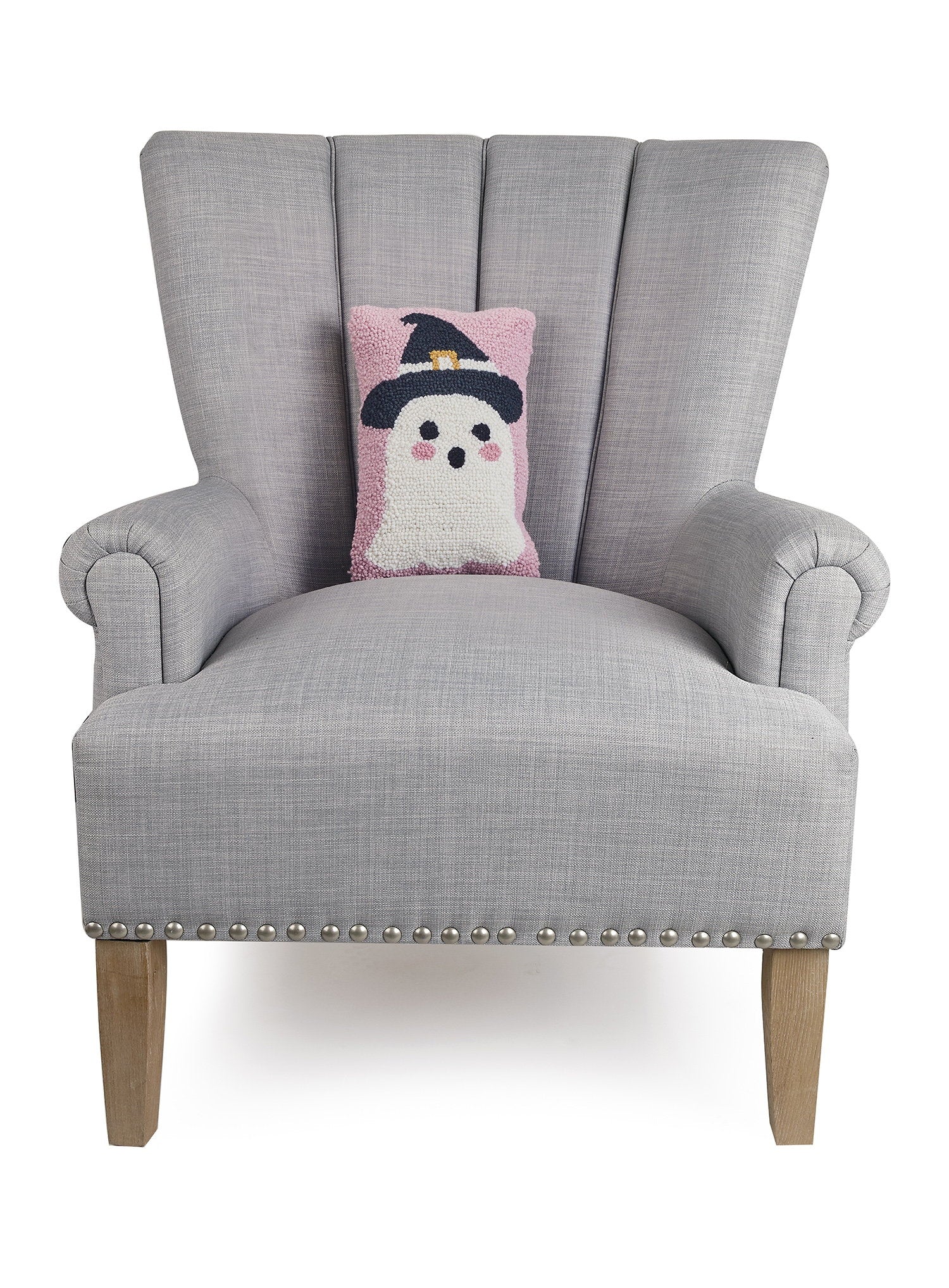 Ghost Witch Hooked Wool Halloween Throw Pillow on an armchair, showing the throw pillow at room scale, 8x12 inch