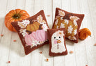 Ghost with Daisies Hooked Wool Halloween Throw Pillow shown alongside other designs in the same collection, 8x12 inch